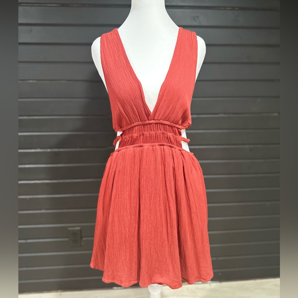 A-line rust color dress with cut outs on both sides, deep V front and back